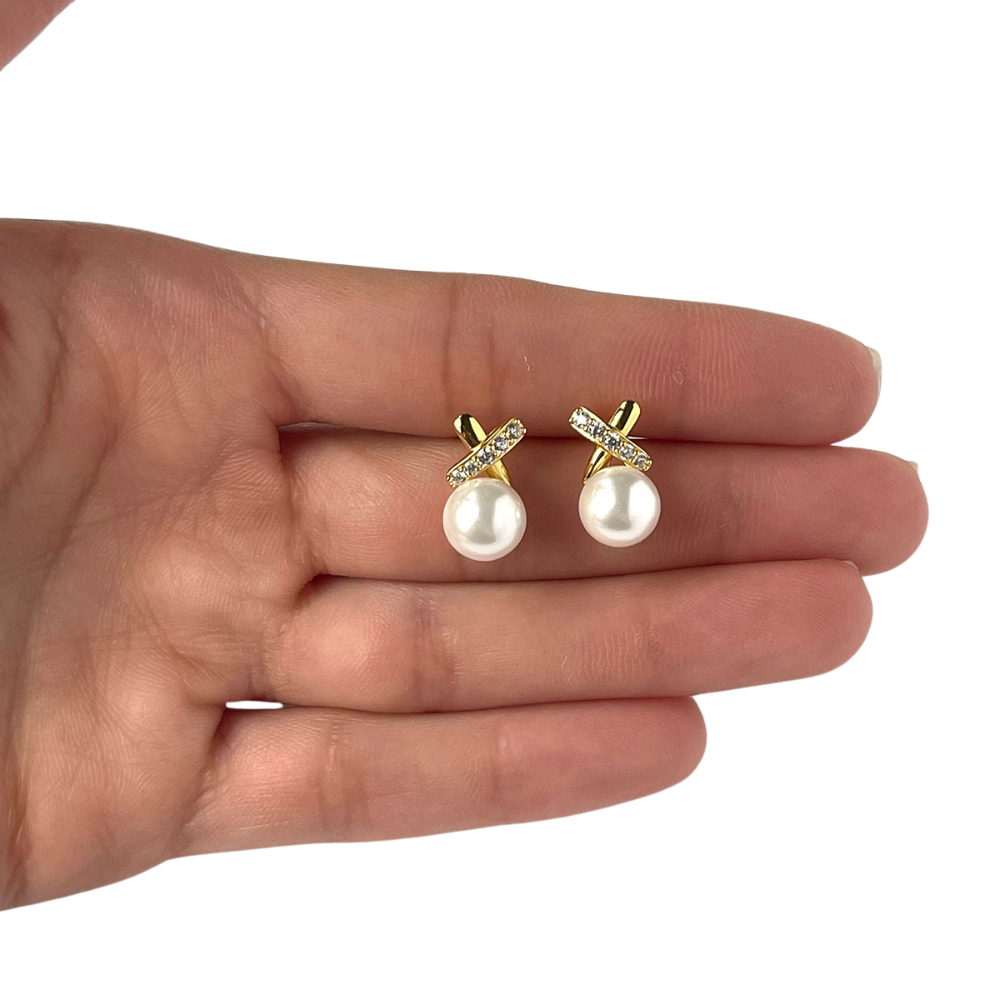 Aretes de plata con baño de oro amarillo con perla y una X arriba con línea de circonitas