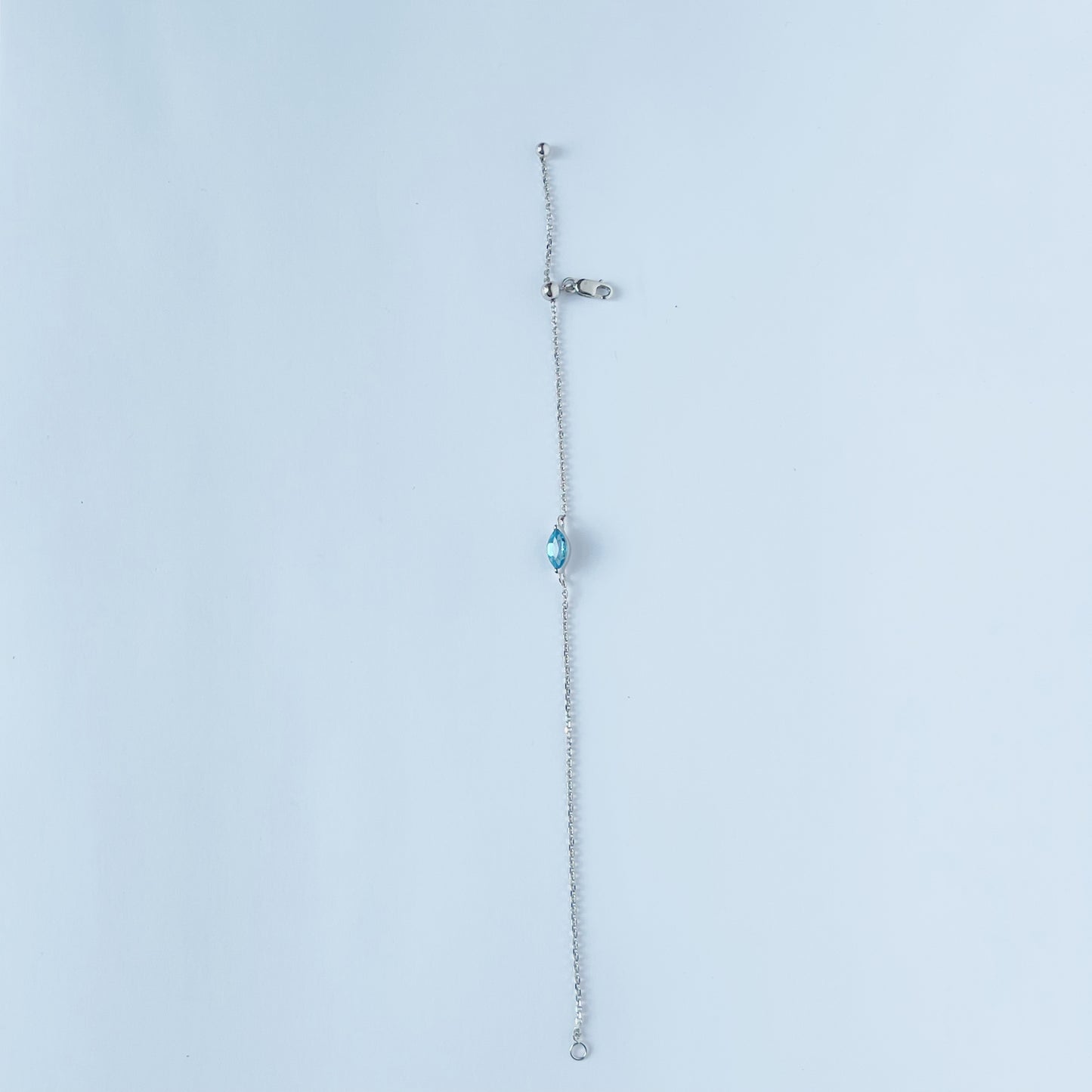 Pulsera en oro blanco 10k con topacio azul