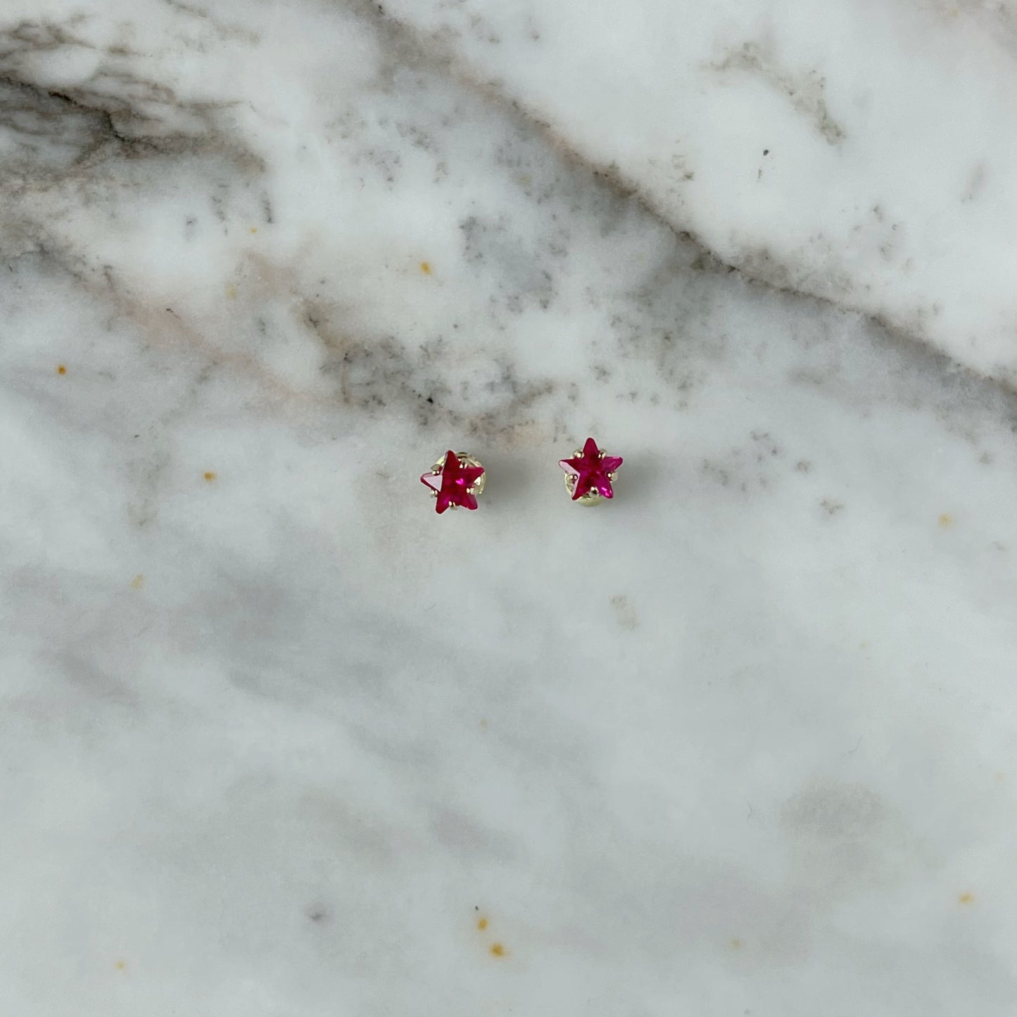 Aretes en oro amarillo 14k estrellas de circonitas rojas con broche rosca