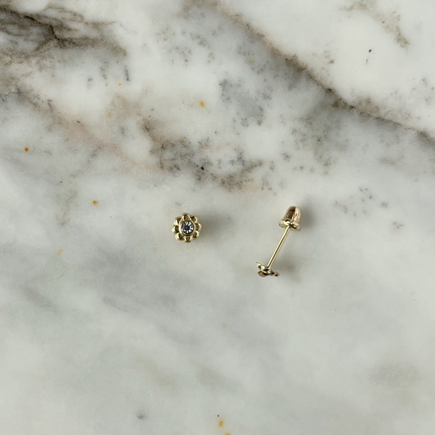Aretes en oro amarillo 14k de flor mini con circón en el centro con broche rosca