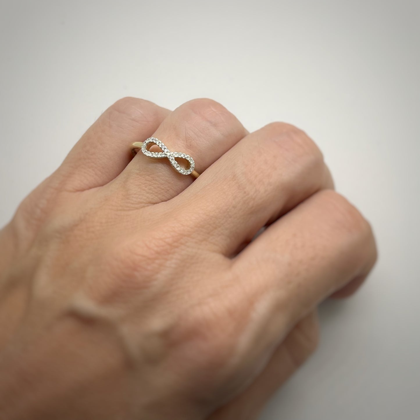 Anillo en oro amarillo 10k con infinito de diamantes 0.11ctw