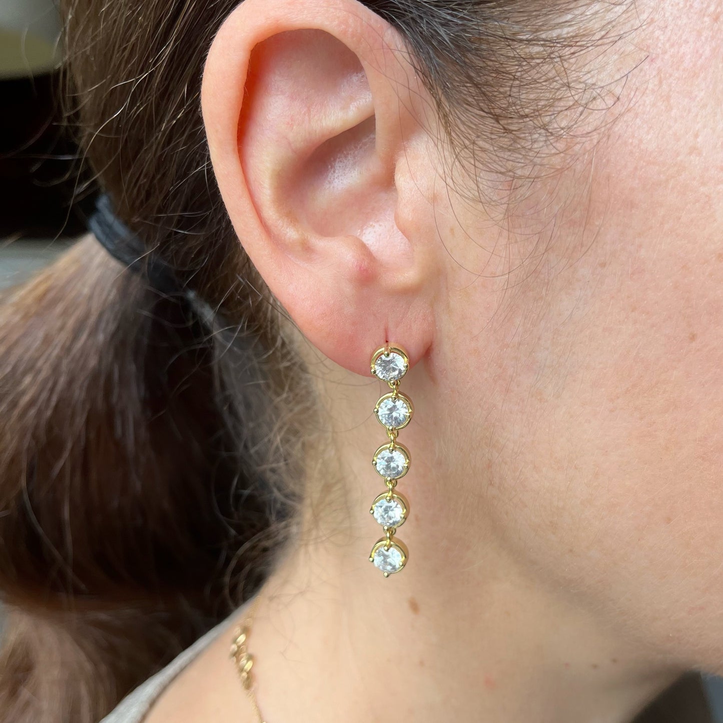 Aretes de plata con baño de oro amarillo y fila de circones colgantes redondos
