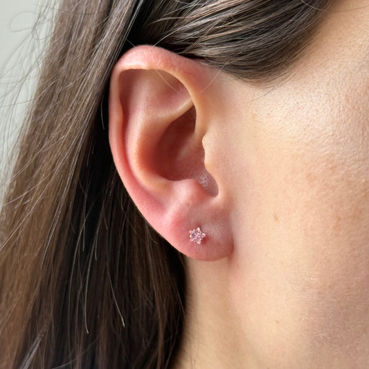 Aretes mini estrella con circón rosado en oro amarillo 14K con tope rosca