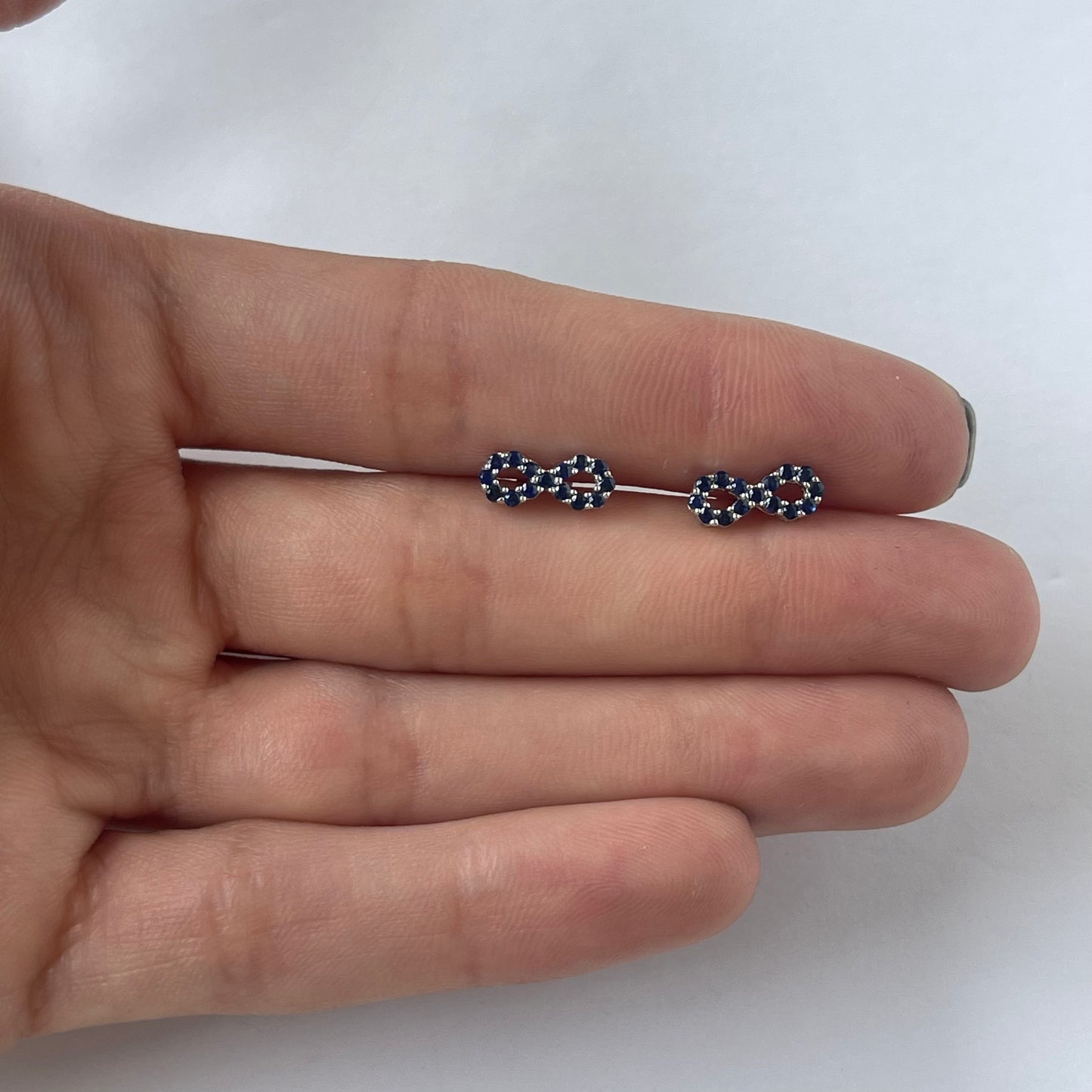Aretes de infinito de zafiros en oro blanco 10k con broche a rosca