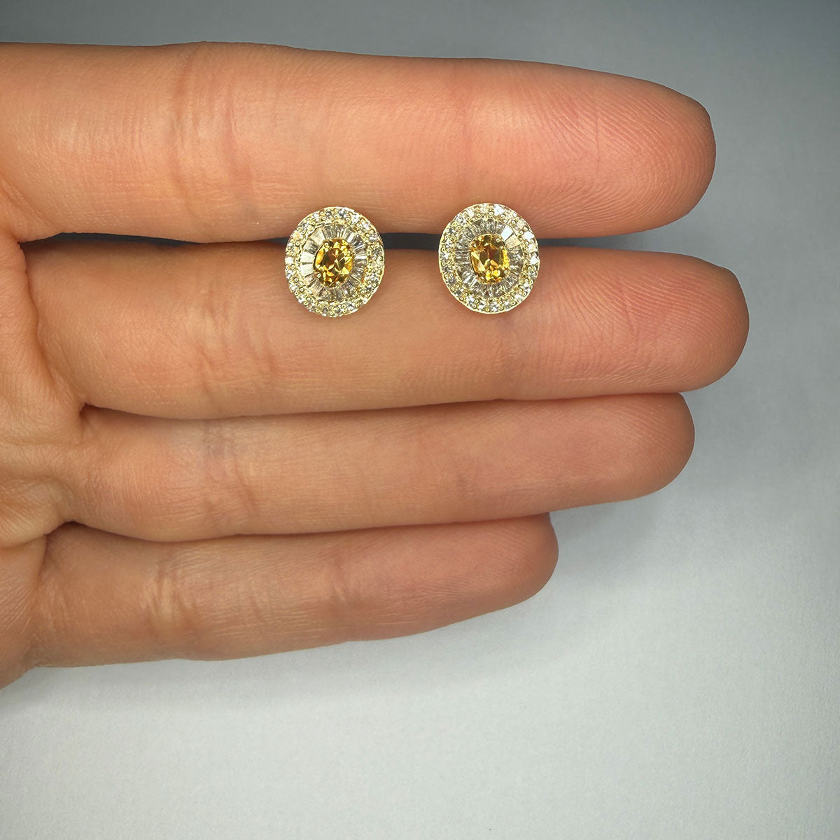 Aretes en oro amarillo 10K con citrino ovalado y halo de diamantes redondos y baguettes 0.40ctw