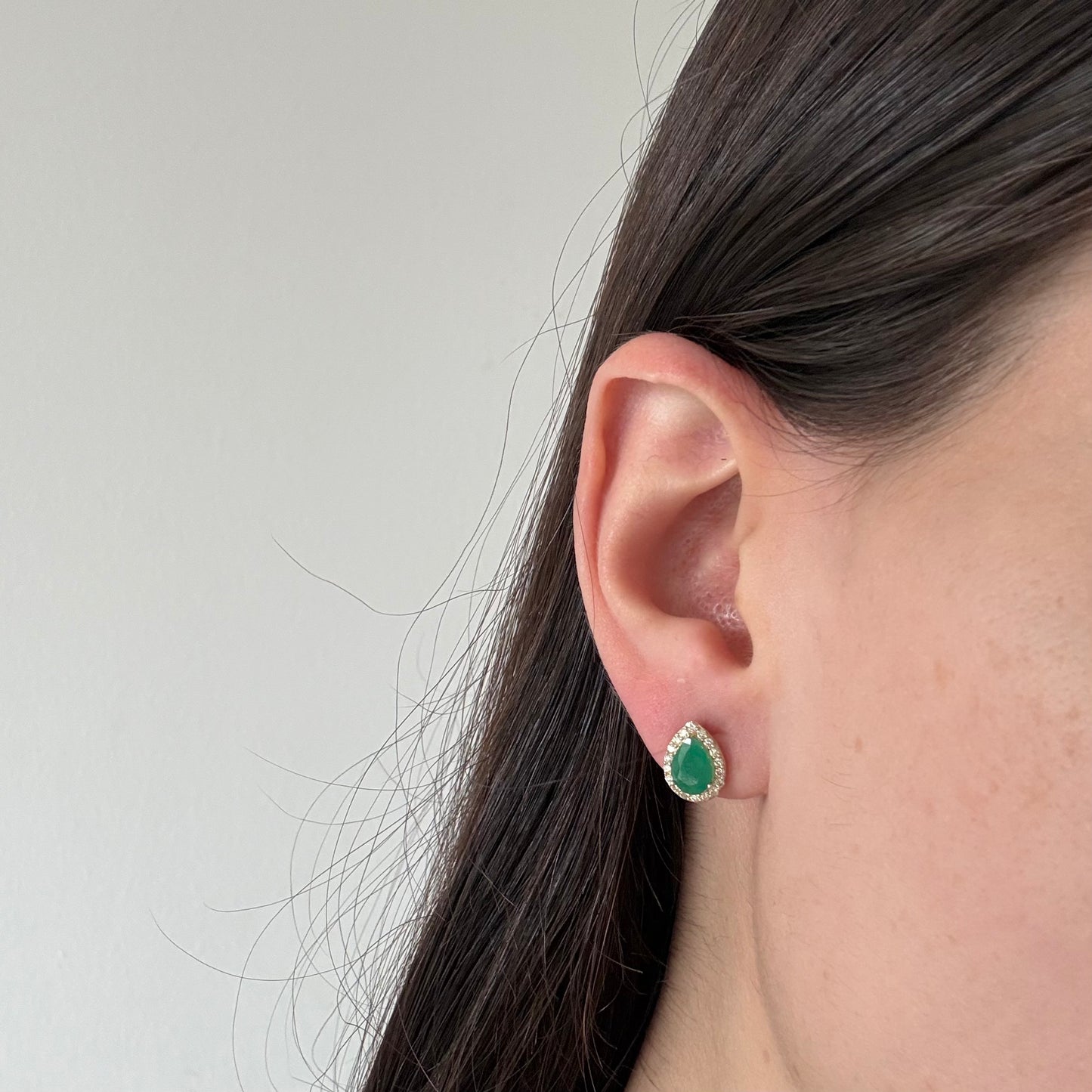Aretes en oro amarillo 10K con esmeralda corte pera y halo de diamantes 0.30ctw