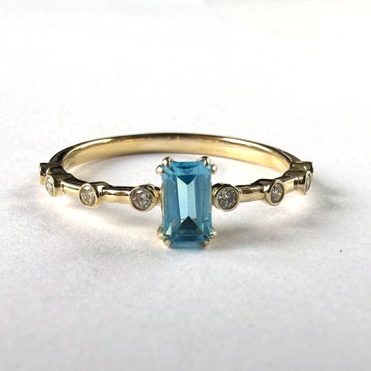 Anillo en oro amarillo 10K con topacio corte esmeralda y diamantes 0.10ctw