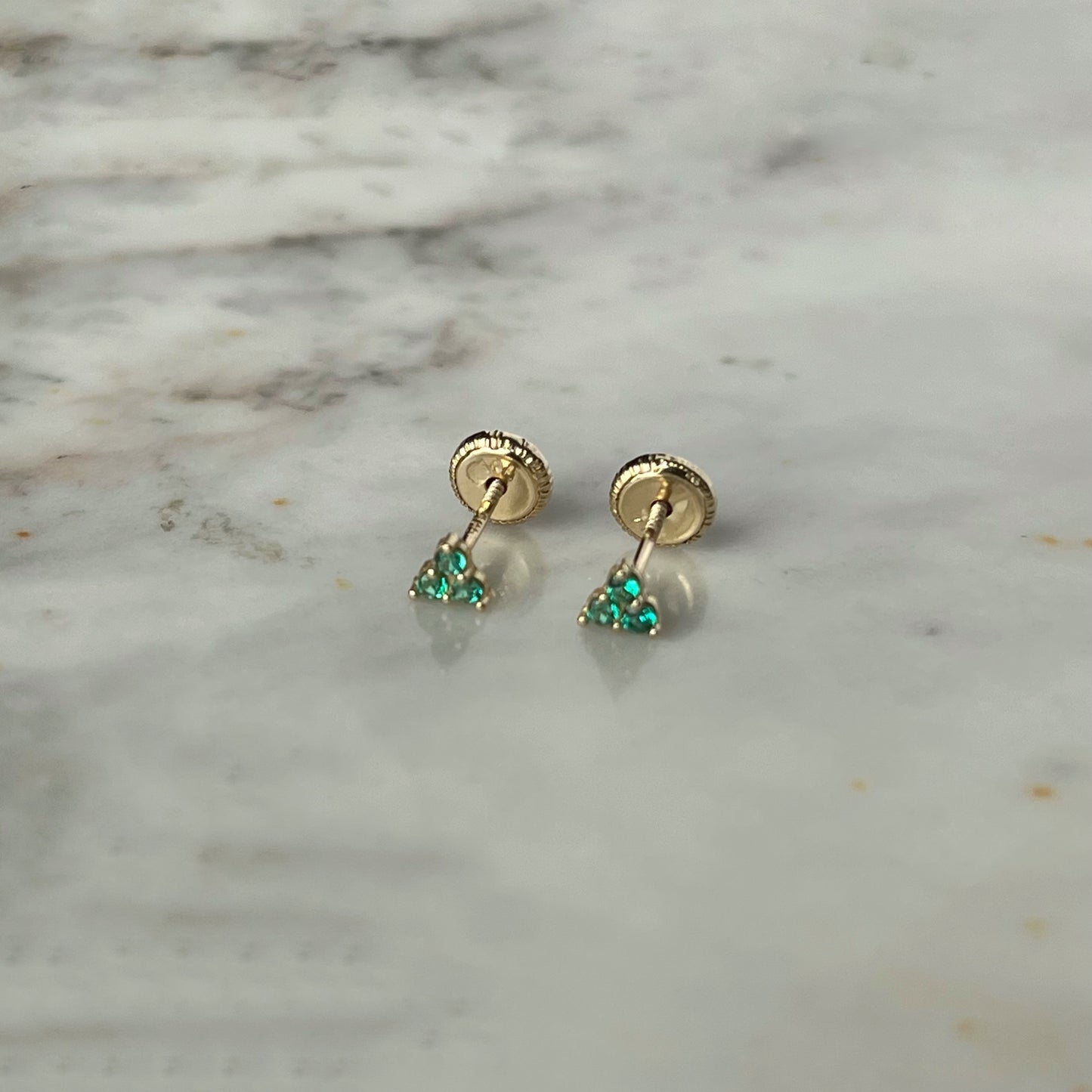 Aretes tres circonitas verdes mini en oro de 14k con tope ortopédico