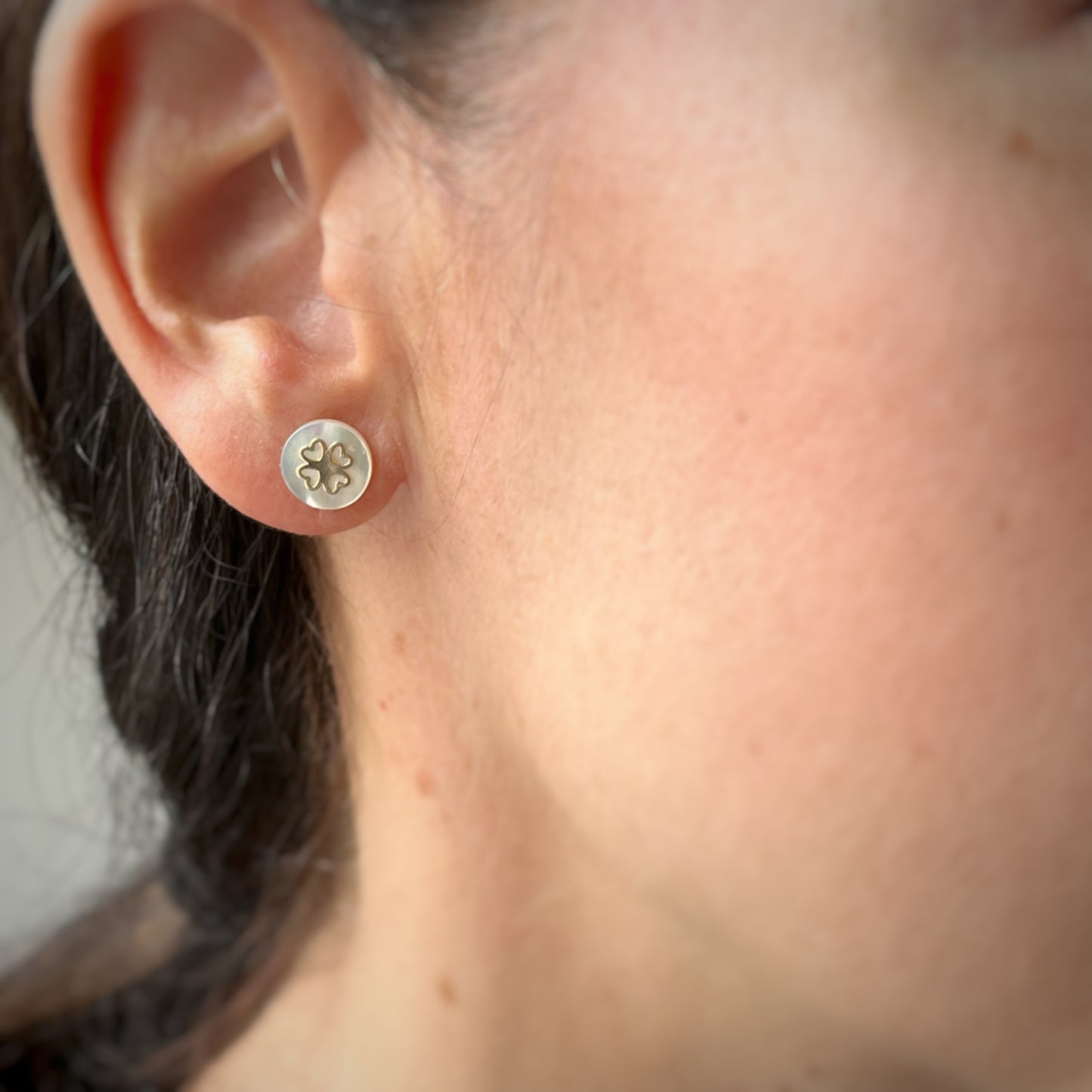 Aretes tope ortopédico madre perla con detalle flor de corazones en oro amarillo de 14k