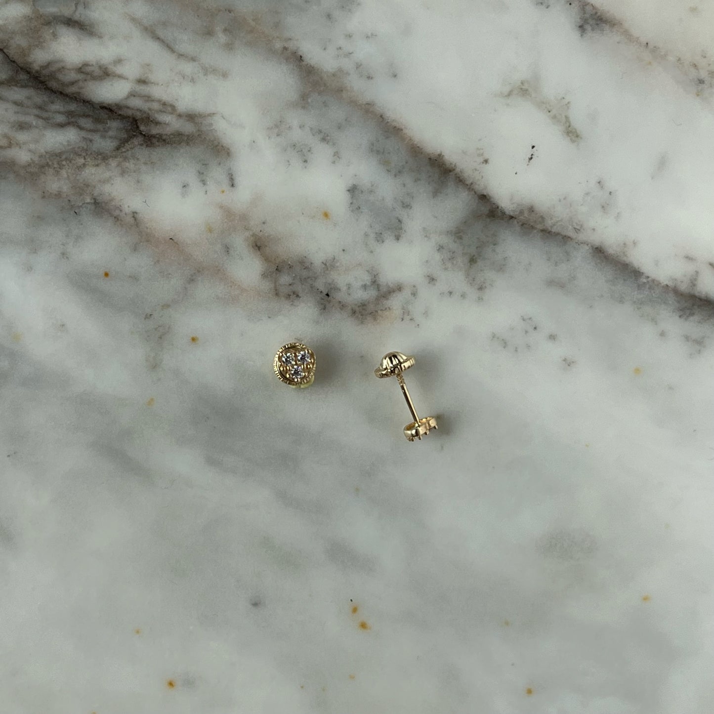 Aretes en forma de corazón con tres circonitas blancas en oro de 14k con tope ortopédico