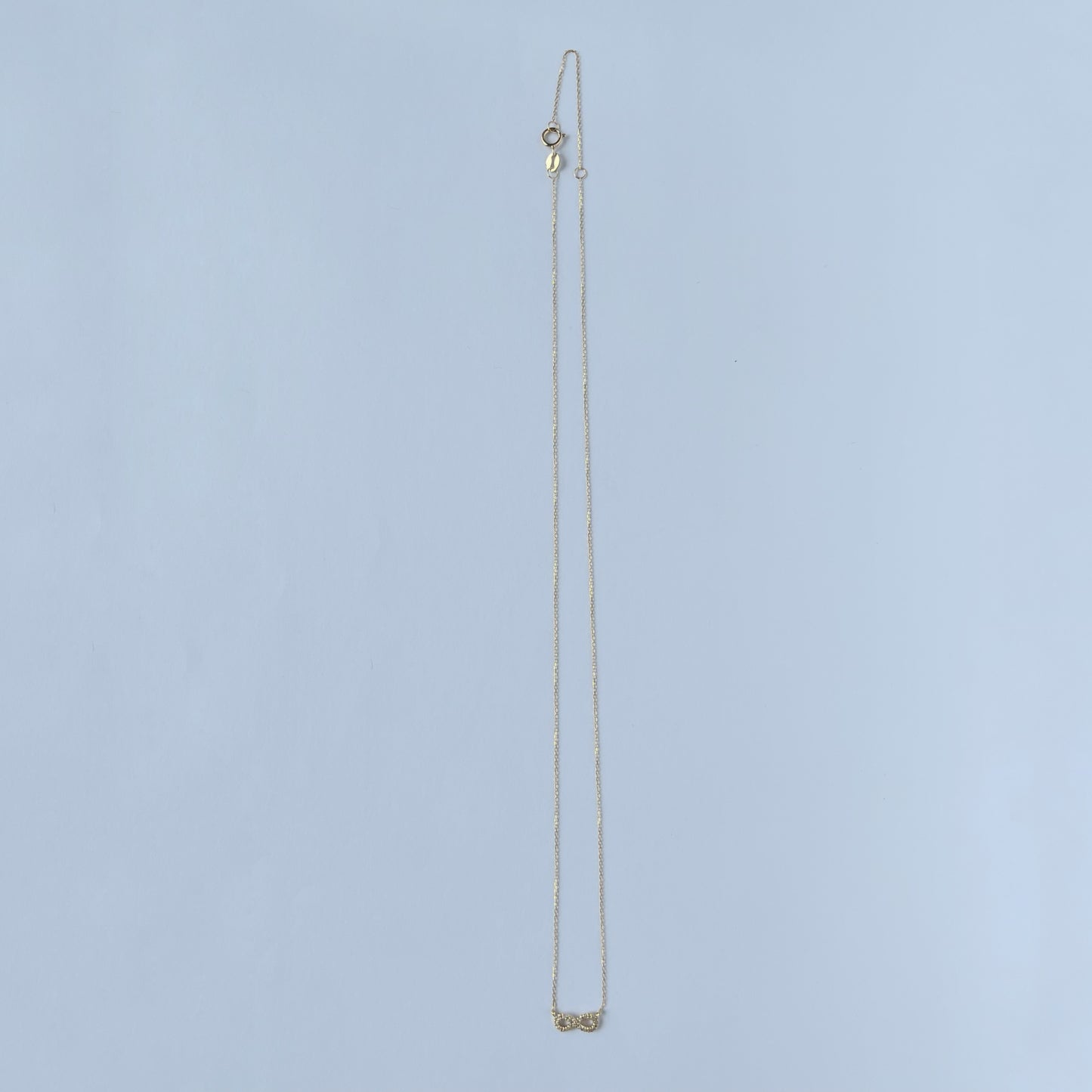 Collar en oro amarillo 14k con infinito de diamantes 0.05ctw