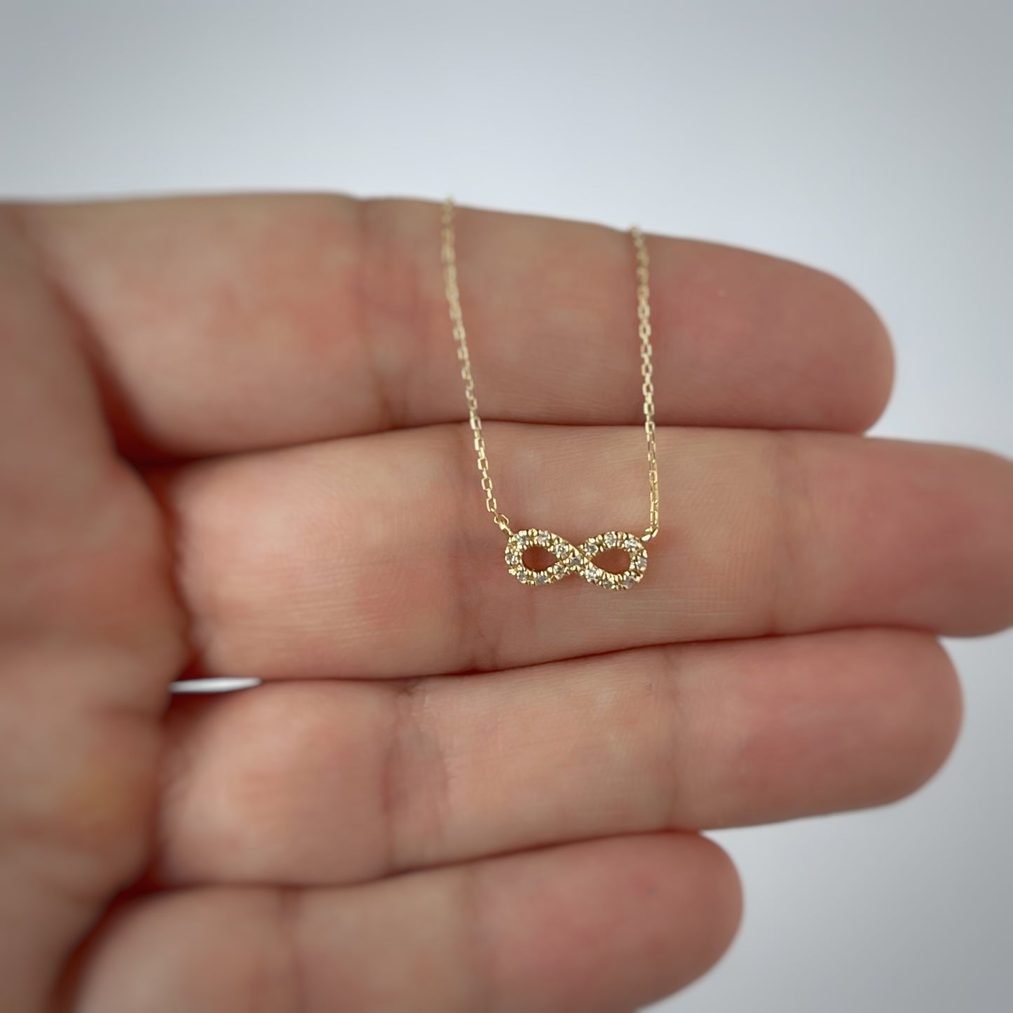 Collar en oro amarillo 14k con infinito de diamantes 0.05ctw