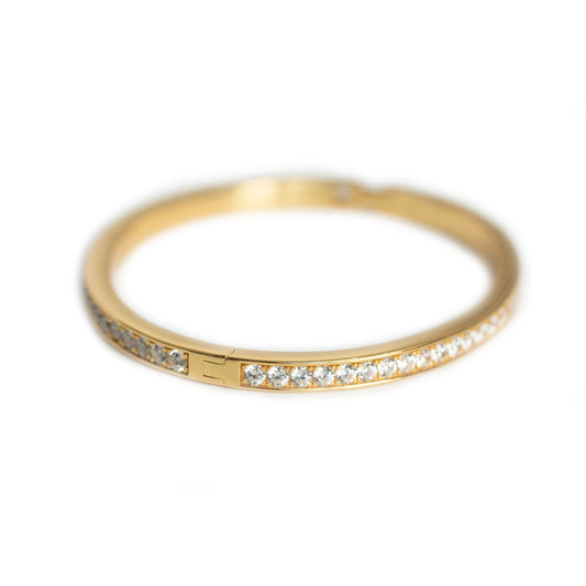 Pulsera dura en plata con baño de oro amarillo y circonitas