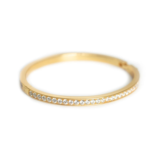 Pulsera dura en plata con baño de oro amarillo y circonitas