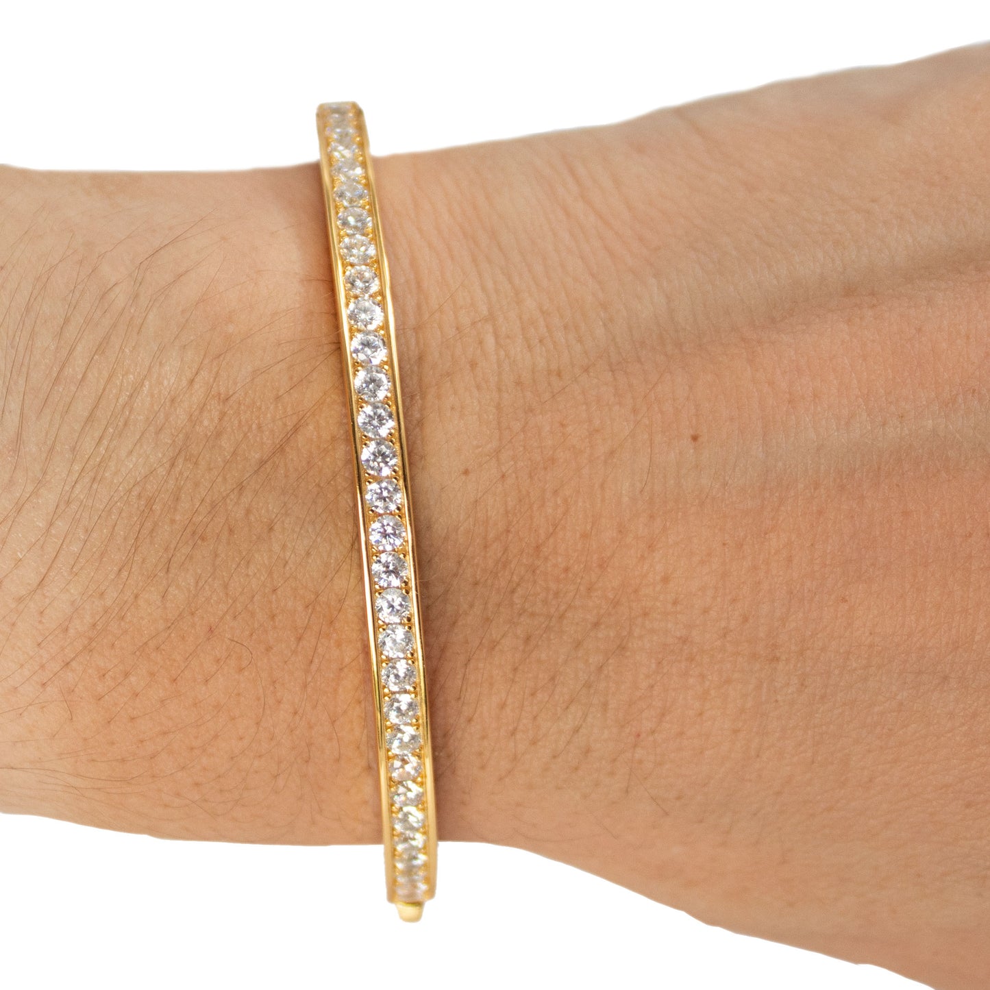 Pulsera dura en plata con baño de oro amarillo y circonitas