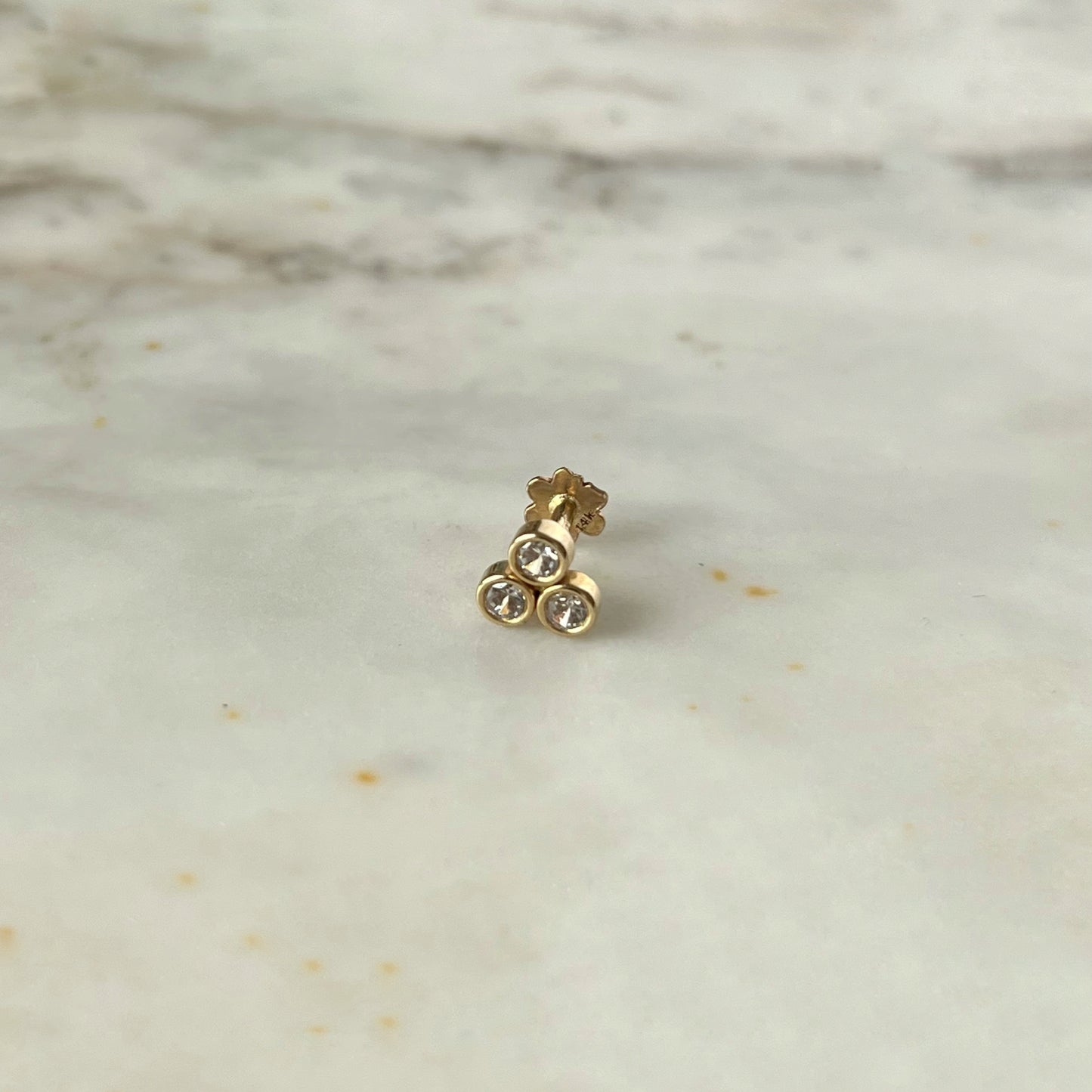 Arete piercing single de 3 circonitas biseladas en oro amarillo de 14 k