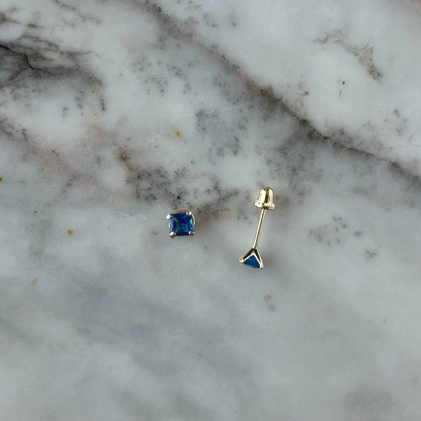 Aretes en oro amarillo 14K con circonita cuadrada azul con tope rosca