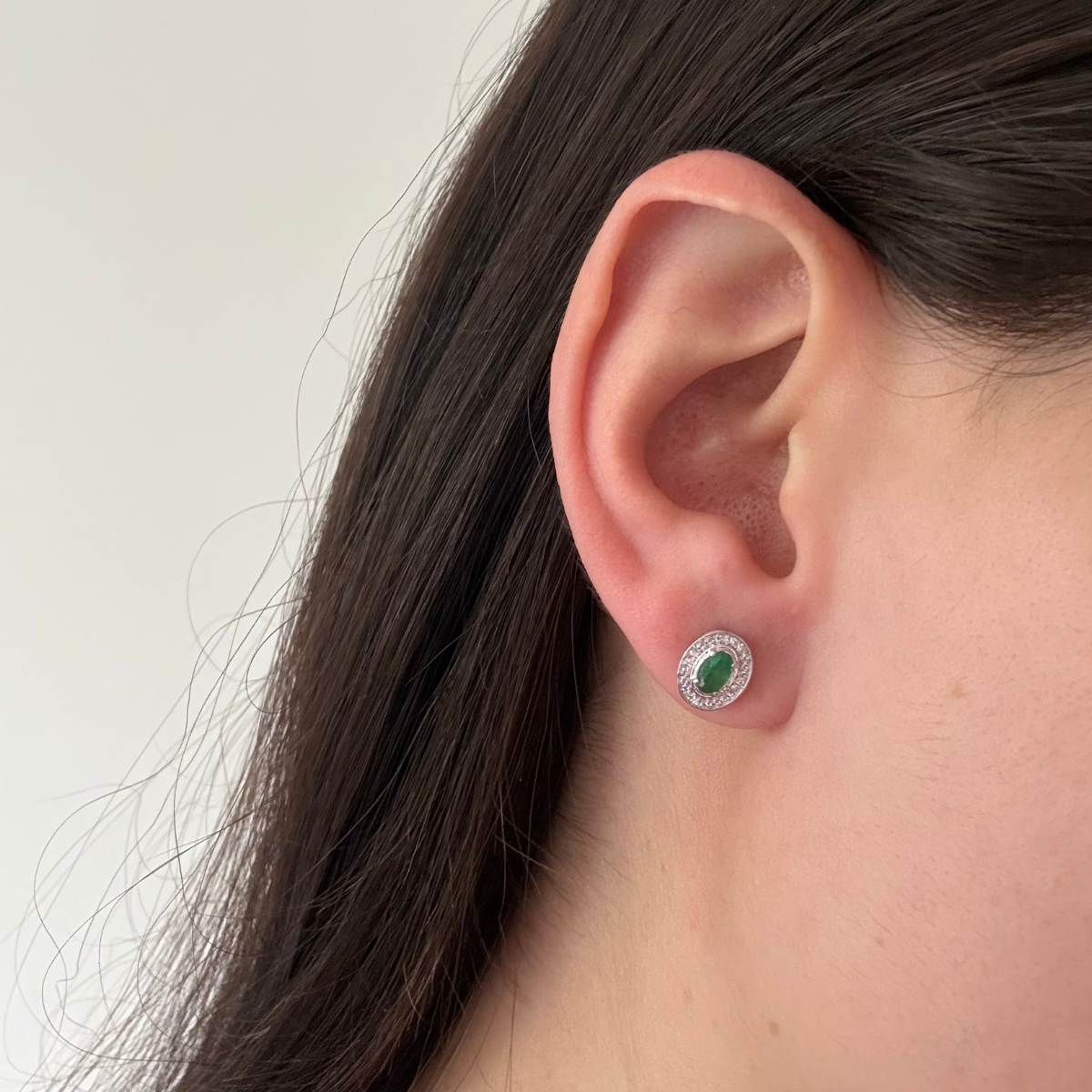 Aretes en oro blanco 10K con esmeralda ovalada y halo de diamantes 0.05ctw