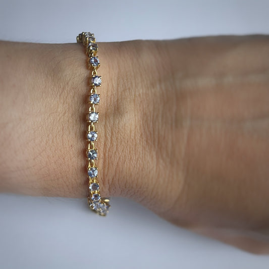 Pulsera de tanzanitas redondas en plata con baño de oro amarillo
