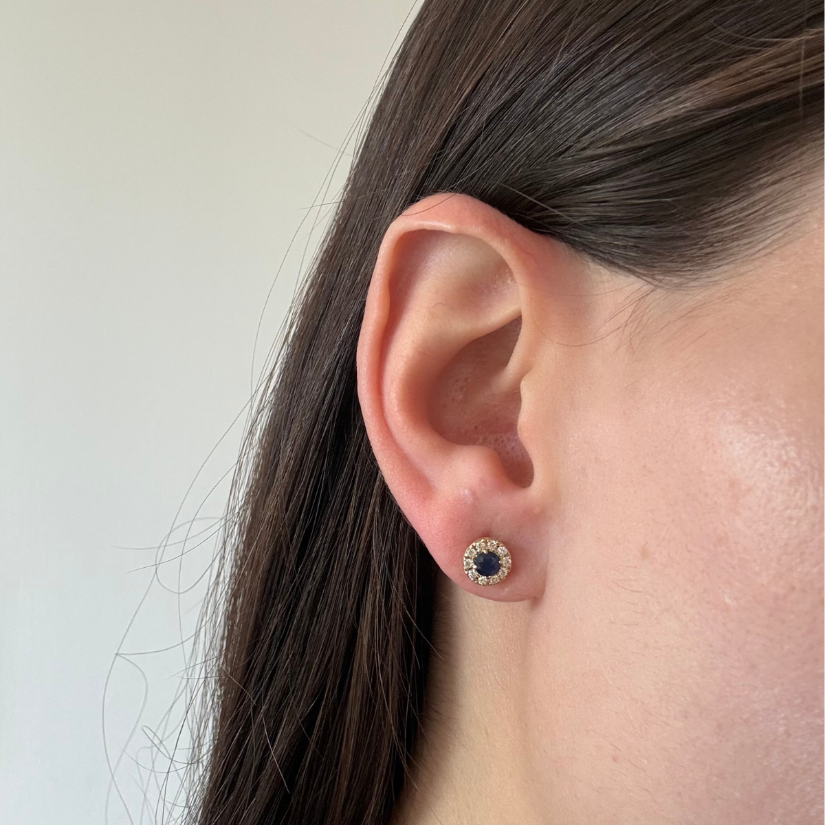 Aretes en oro amarillo 14K con zafiro redondo y halo de diamantes 0.20ctw