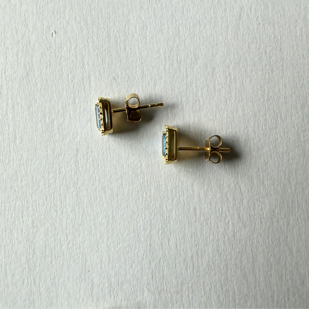 Aretes en oro amarillo 10k con zafiros corte esmeralda y halo de diamantes 0.13ctw