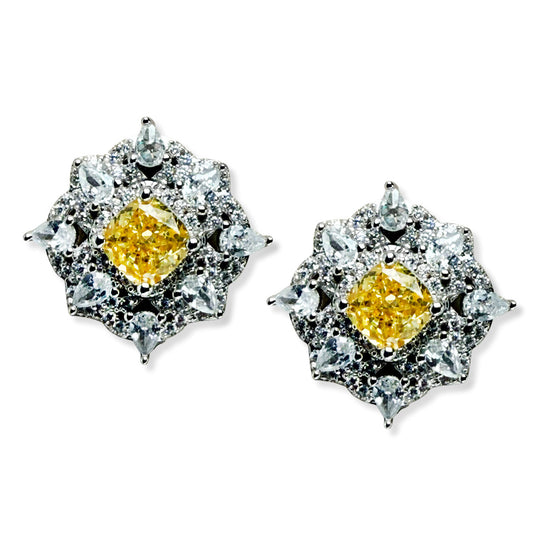 Aretes de plata con baño platino en forma de rombo con circonita amarilla en el centro