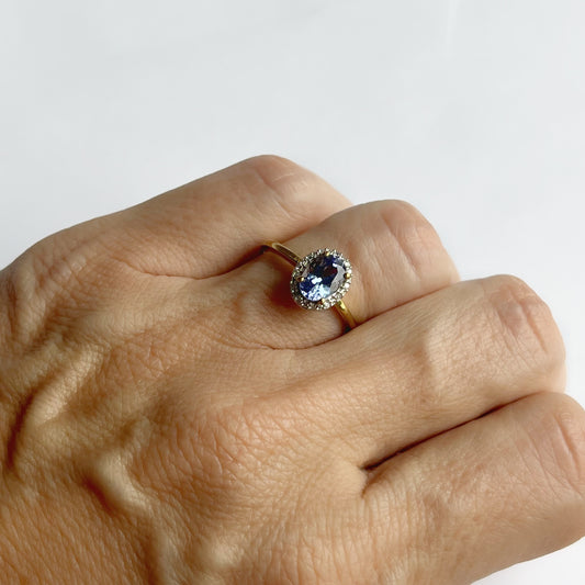 Anillo de oro amarillo 10k con tanzanita ovalada y halo de diamantes