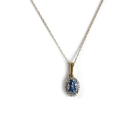 Collar en oro amarillo 10k con dije de tanzanita ovalada y halo de diamantes