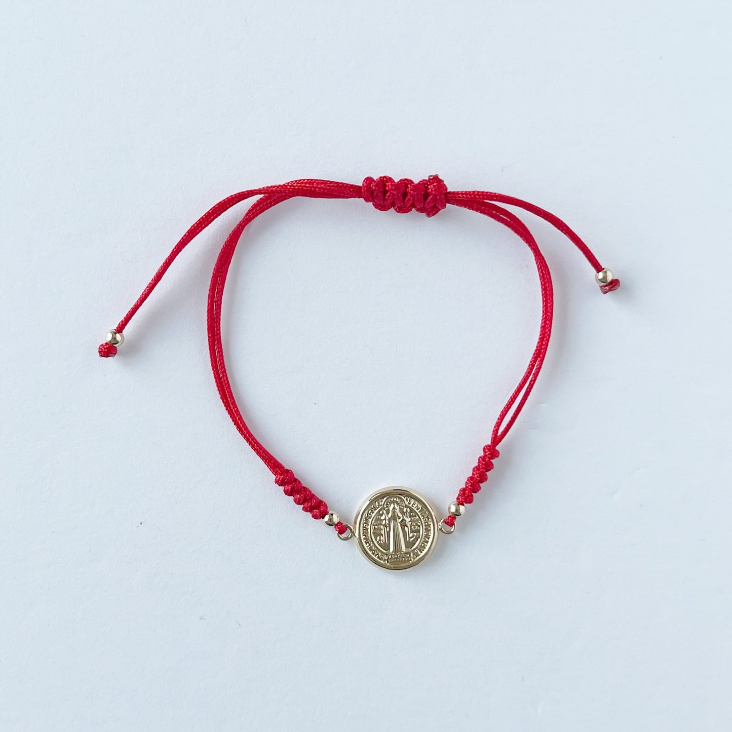 Pulsera de San benito mediana en oro amarillo de 14K con cordón rojo