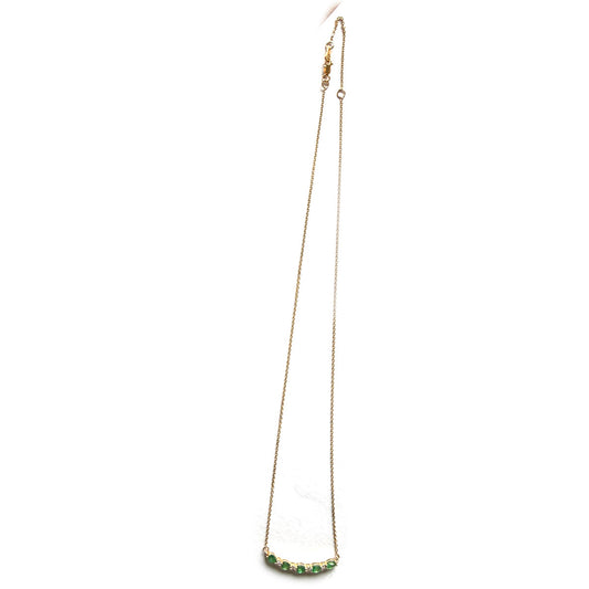 Collar en oro amarillo 10k con curva de esmeraldas y diamantes