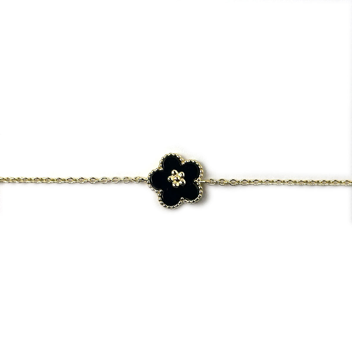 Pulsera de plata con baño de oro con flor de esmalte negro