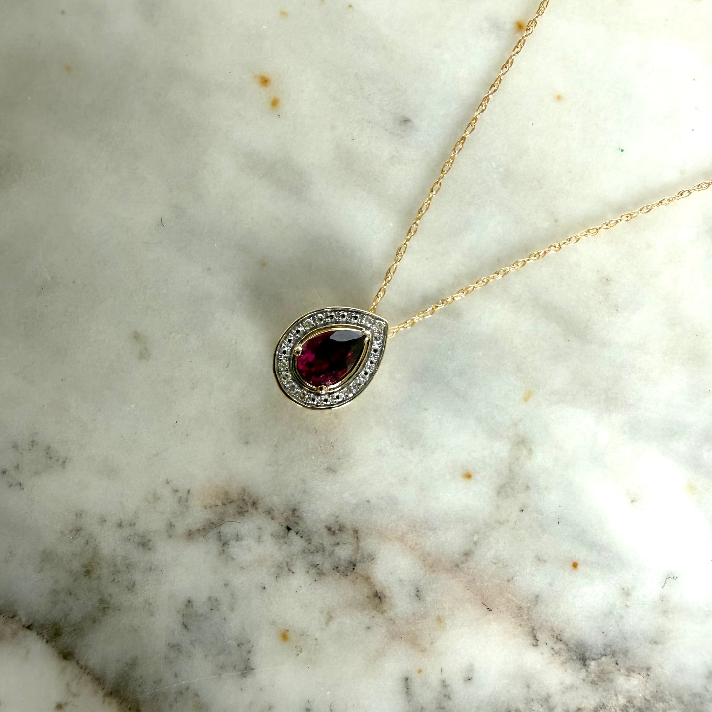 Collar en oro amarillo 10K con gota de granate rodolita y halo de diamantes 0.05ctw