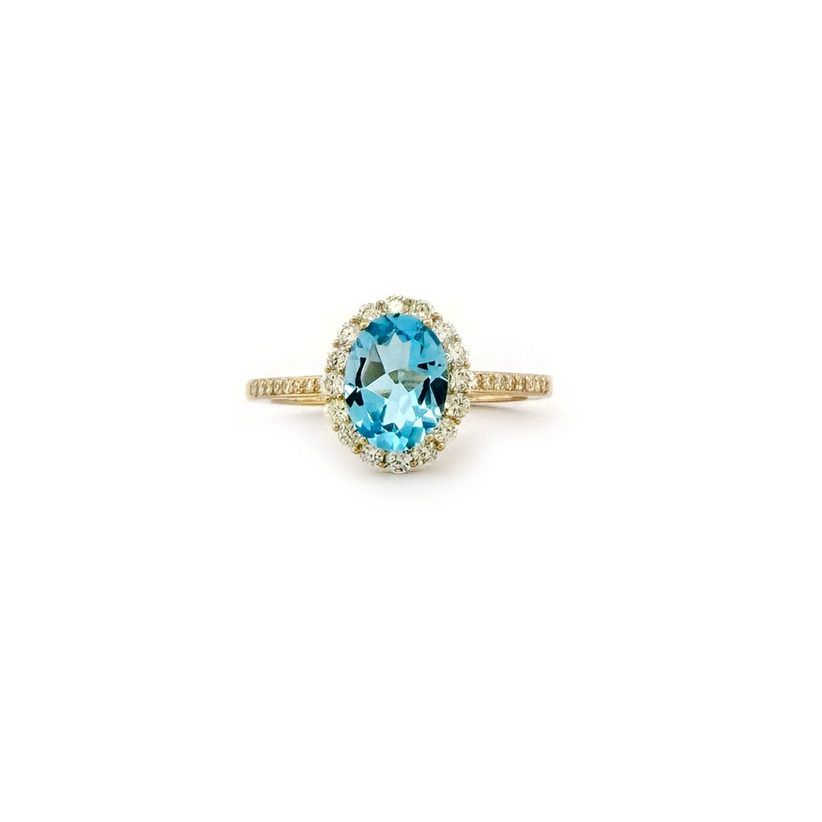 Anillo en oro amarillo 10K con topacio azul ovalado y halo de diamantes 0.35ctw