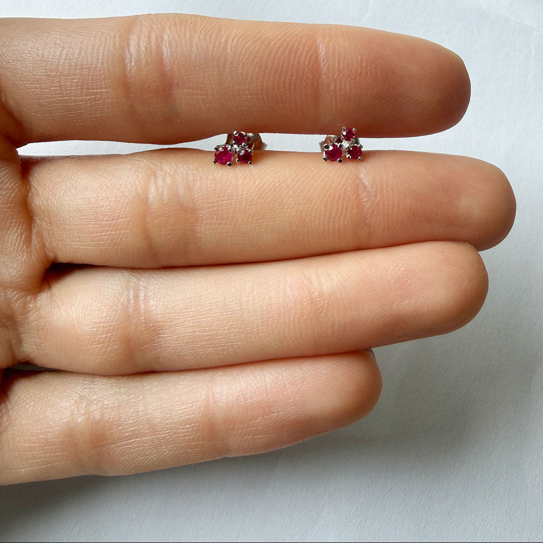 Aretes en oro blanco 14K con tres rubíes redondos