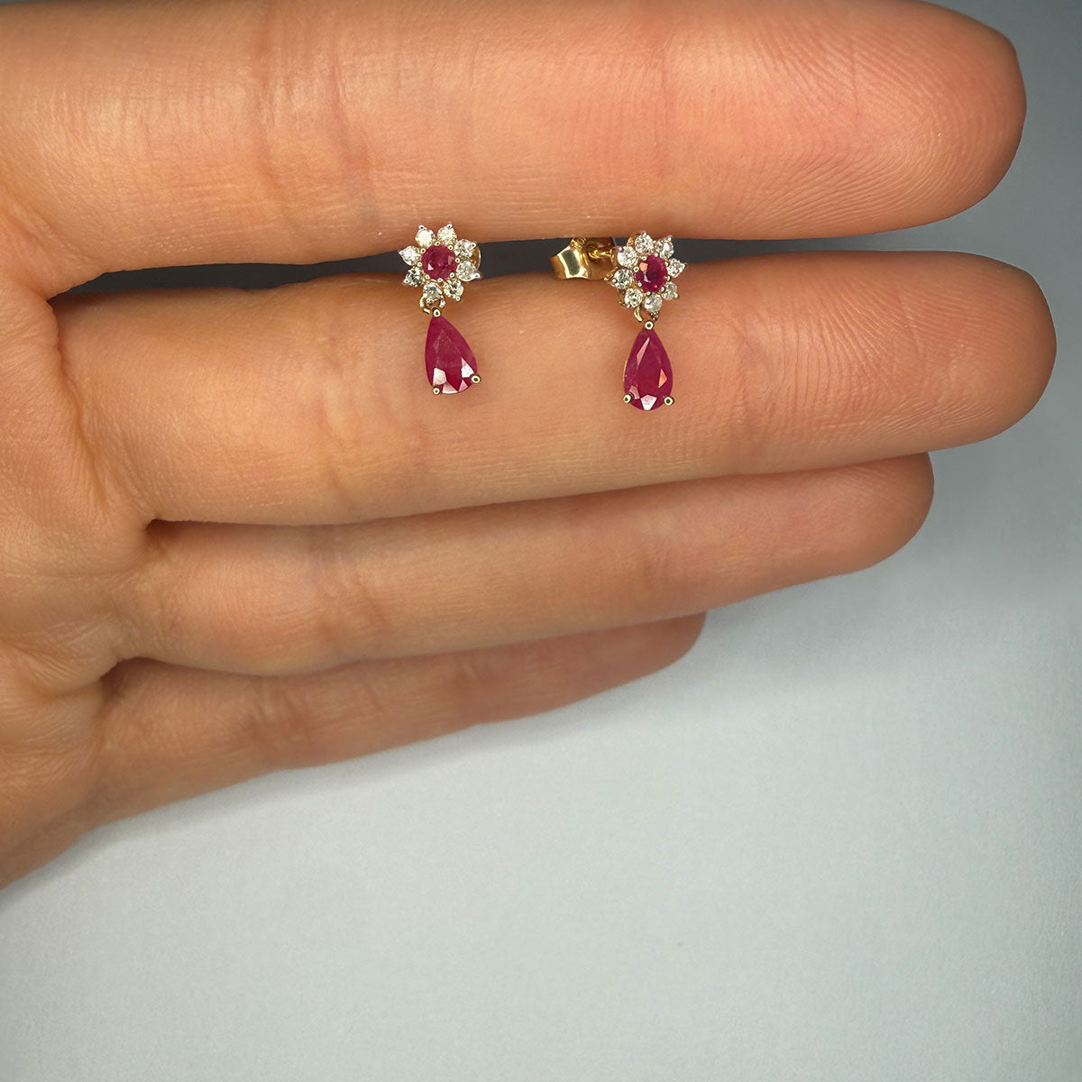Aretes en oro amarillo 10K con flor de diamantes y centro de rubí y gota de rubí colgante