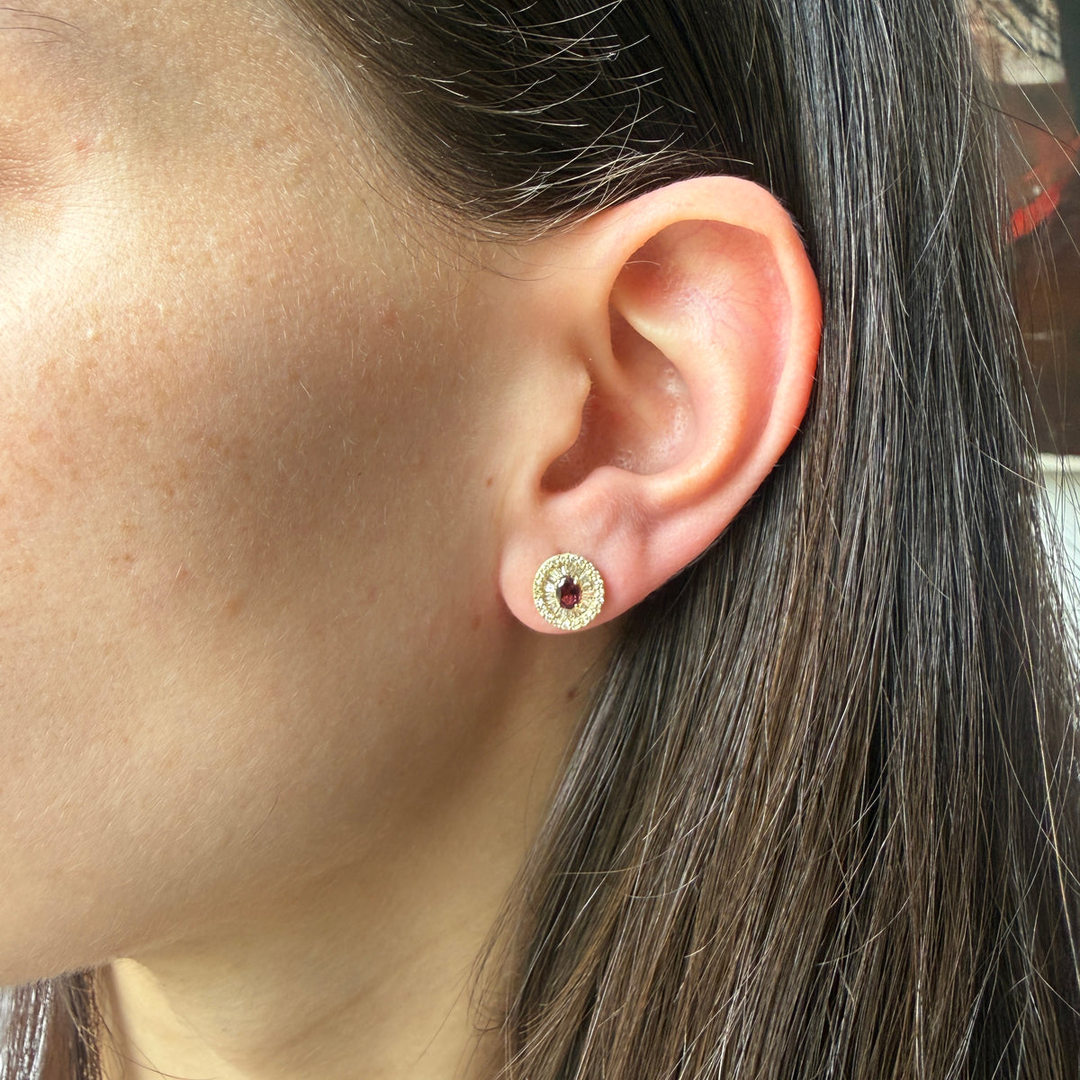 Aretes en oro amarillo 10K con granate ovalado y halo de diamantes redondos y baguettes 0.40ctw