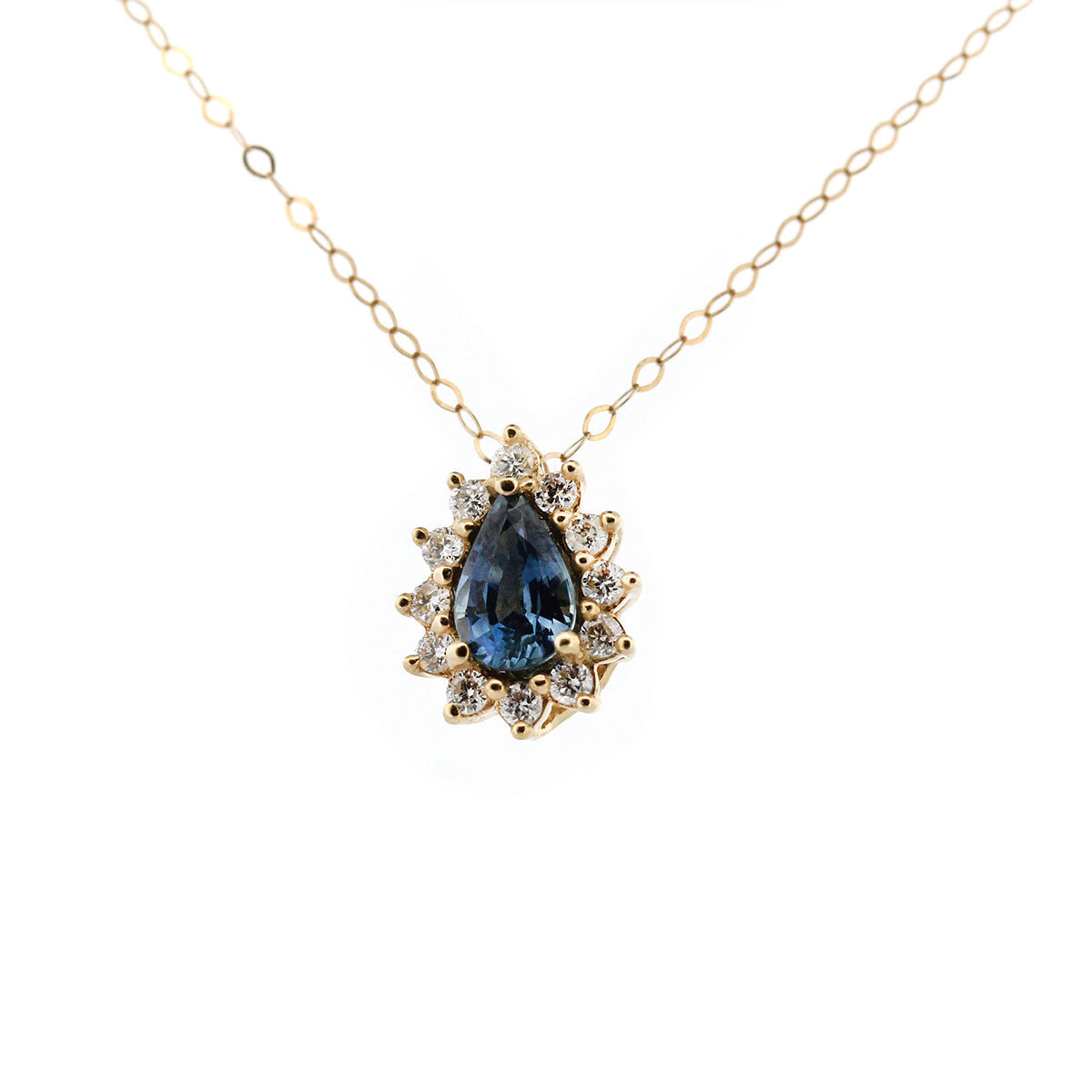 Collar en oro amarillo 14k con zafiro azul corte pera y halo de diamantes 0.20ctw
