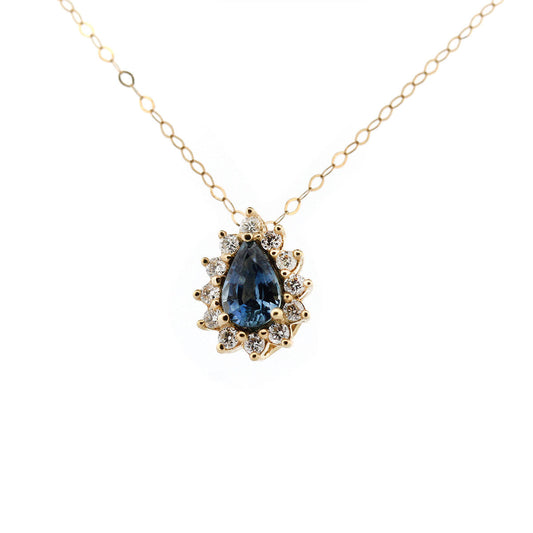 Collar en oro amarillo 14k con zafiro azul corte pera y halo de diamantes 0.20ctw