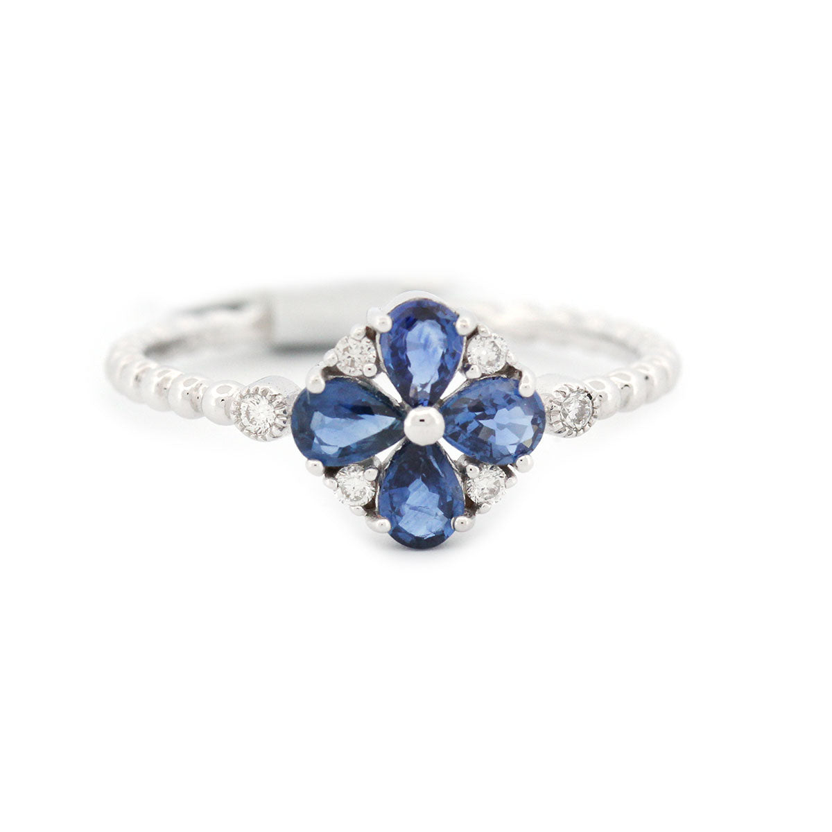 Anillo en blanco 14K con flor de zafiros y diamantes 0.18ctw en aro de bolitas