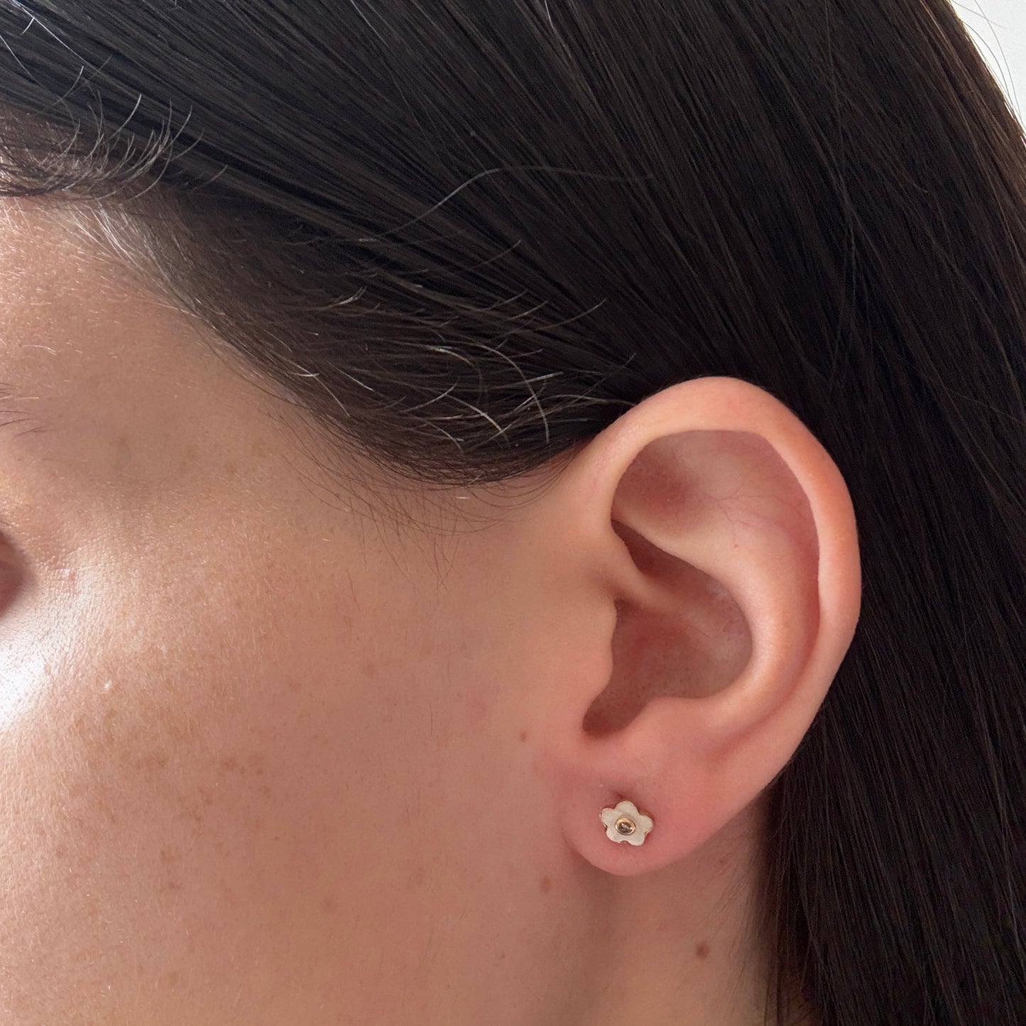 Aretes en oro amarillo 14K con flor de madre perla y centro de circonita con tope rosca