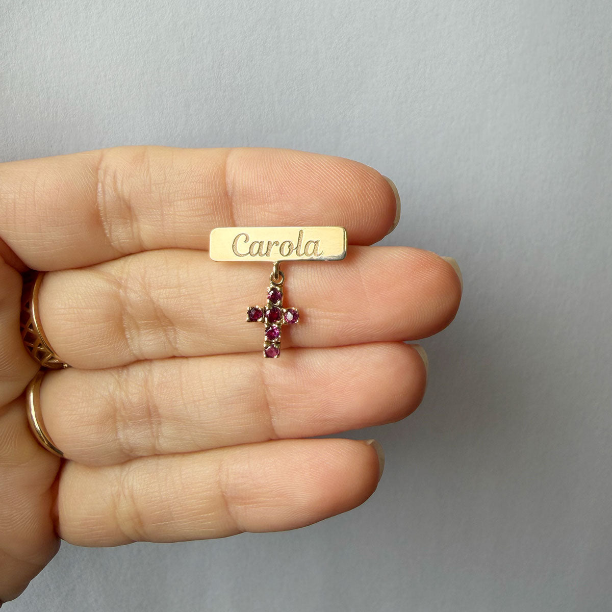 Prendedor con nombre en oro amarillo 14K con cruz de rubíes