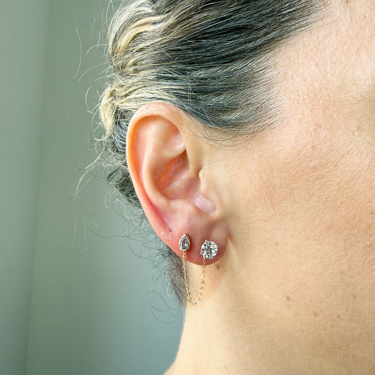 Arete en oro amarillo 14k con circonita gota celeste con cadena