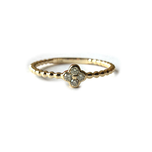 Anillo en oro amarillo 10k de bolitas con mini flor de diamantes 0.10ctw