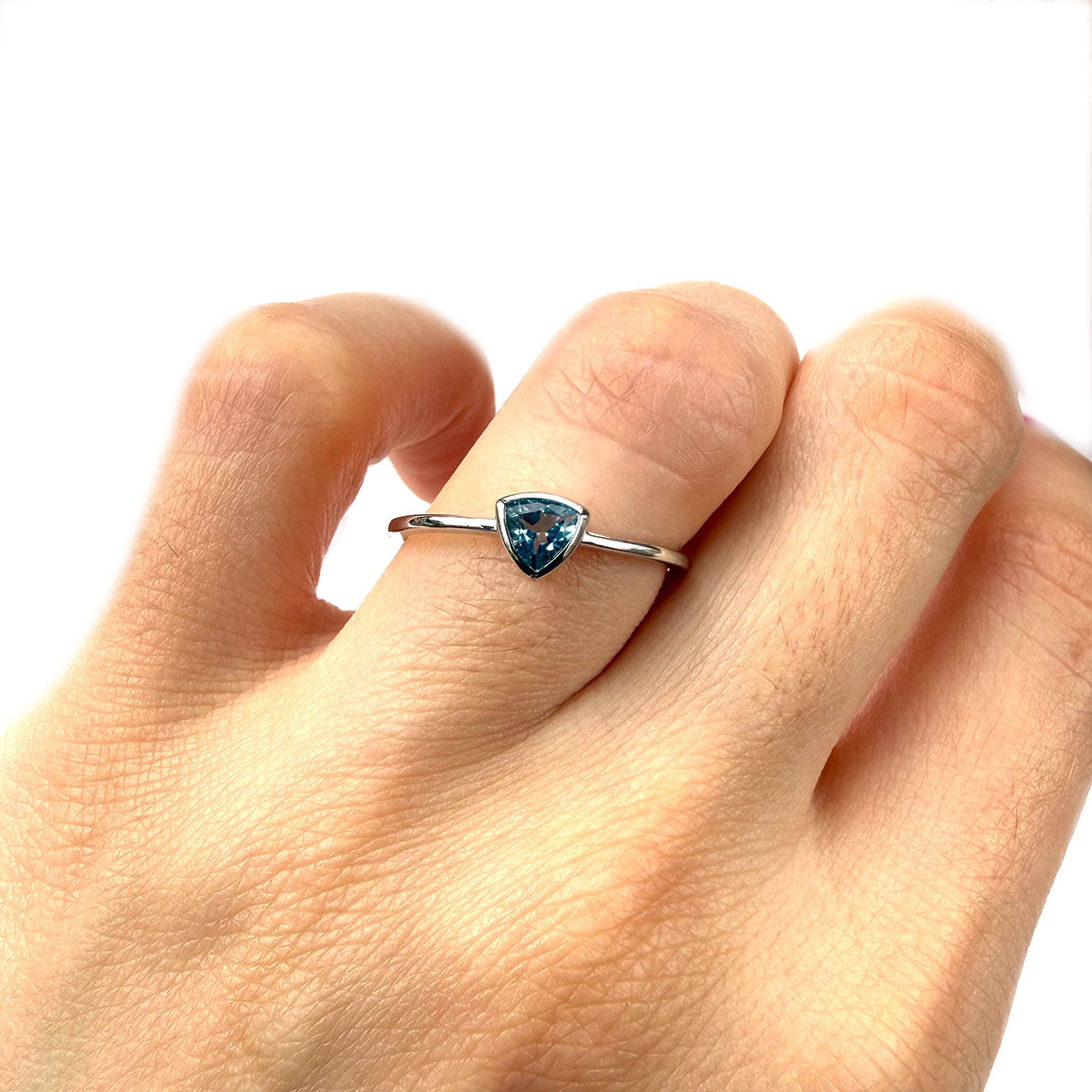 Anillo en oro blanco 10K con topacio azul trillion biselado