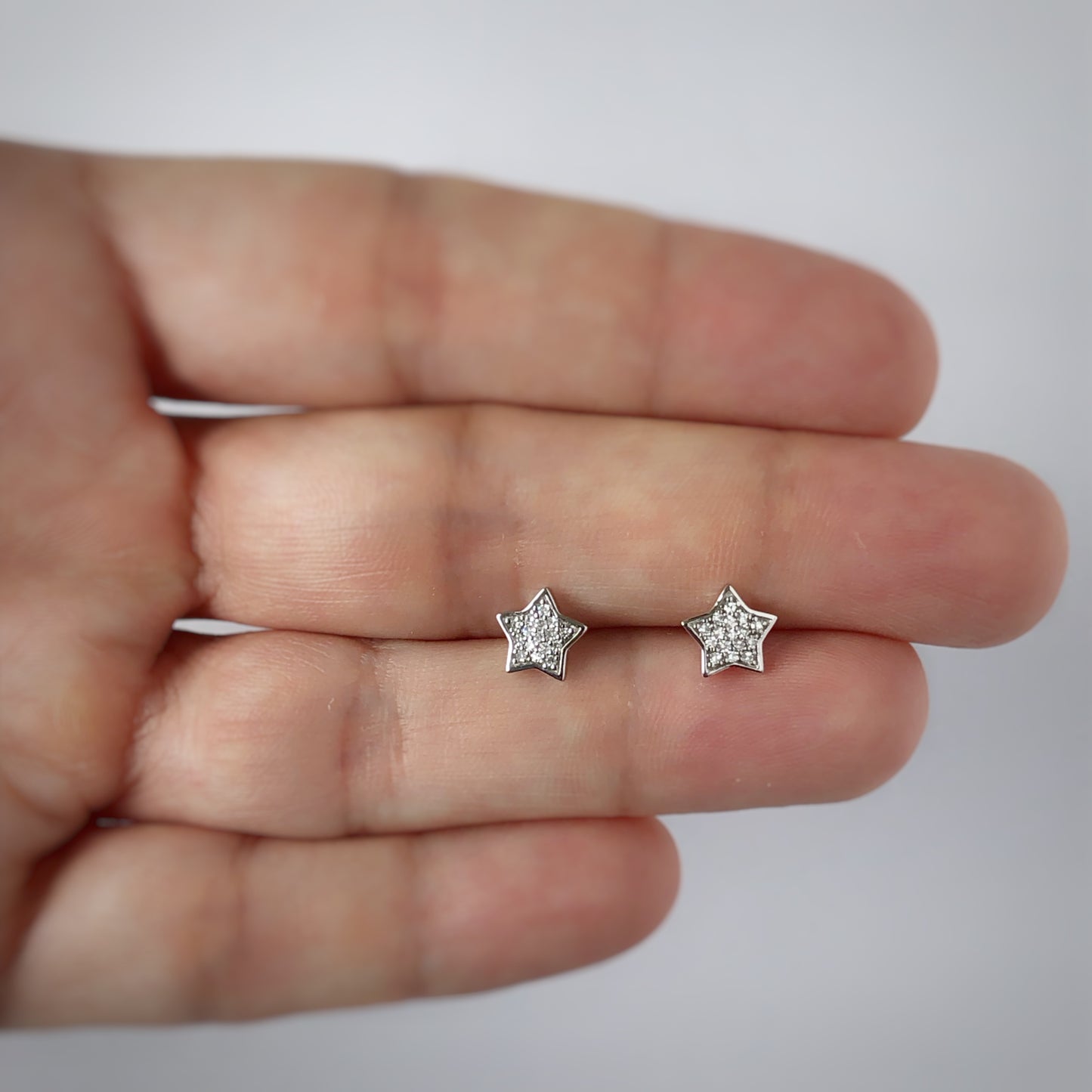 Aretes estrella de diamantes 0.10ctw en oro blanco de 10k